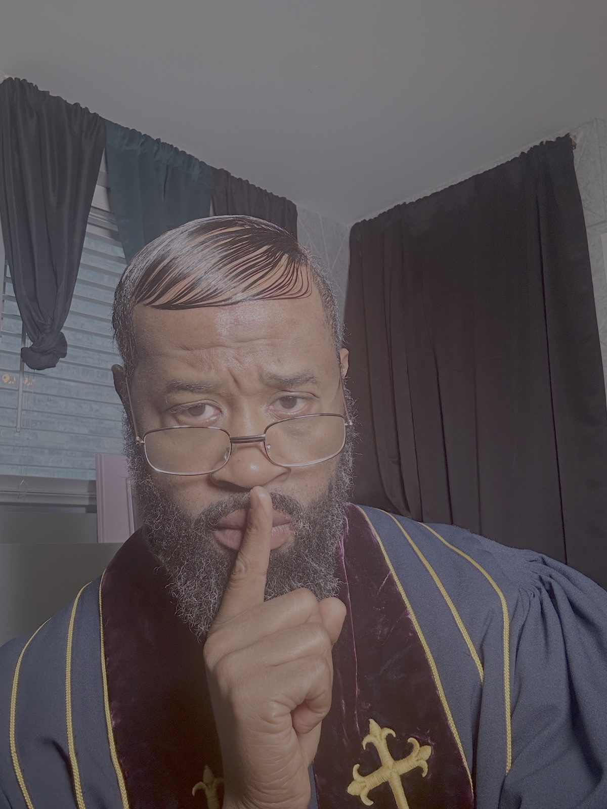 Pastor Leviticus, finger to his lips